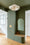 Couloir d'entrée peint en vert sauge avec porte assortie et paniers tressés — projet Atelier Valentina Bagnoli